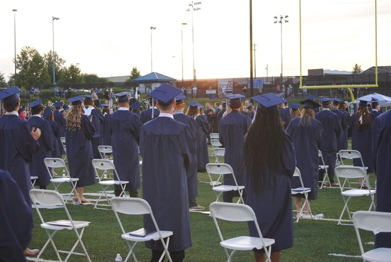 grads standing at ceremony