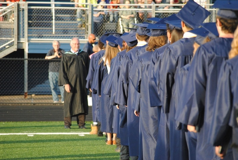 grads lining up to receive diploma
