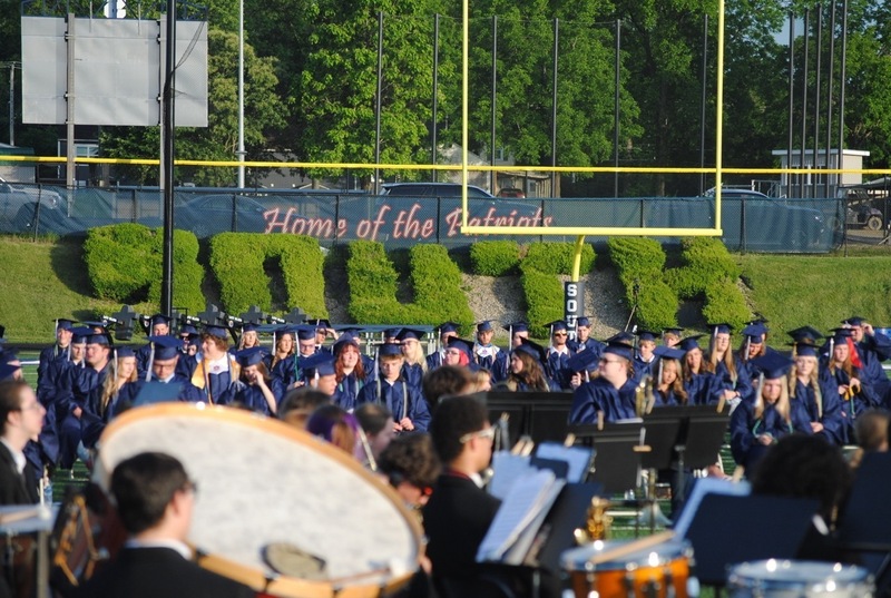 graduates listening to band