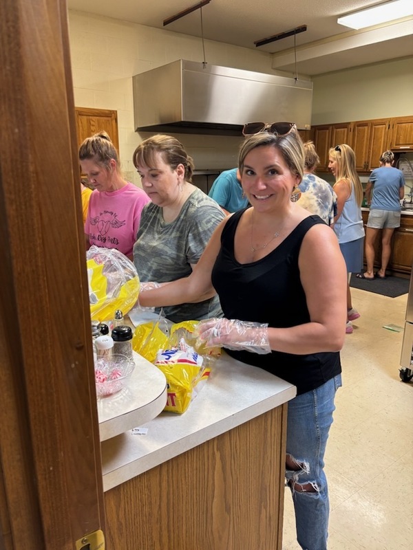 volunteers packing lunches for students