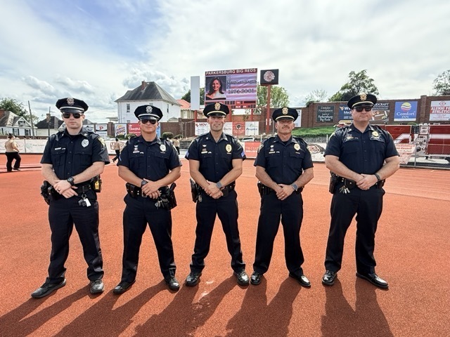 five male police officers standing for camera