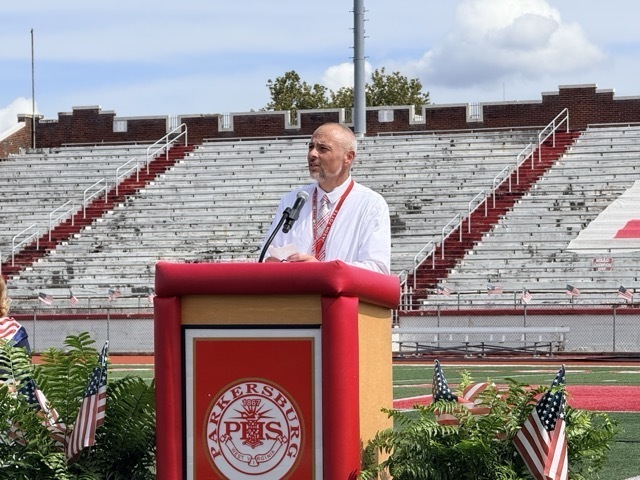 image of high school principal standing at a podium