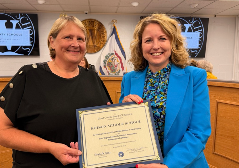 Edison principal receiving award
