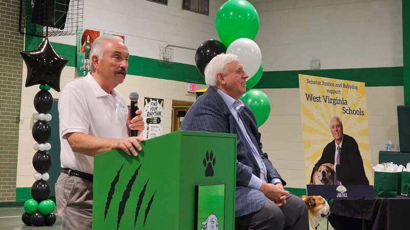 Vernon Criss at a podium with Senator Jim Justice