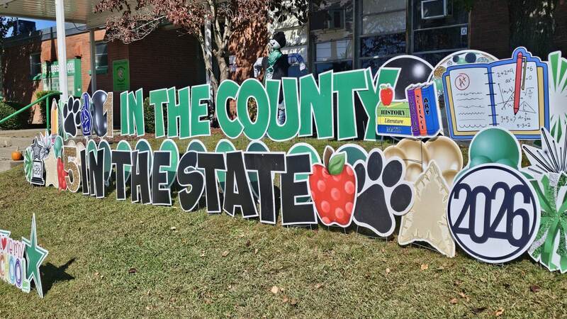 sign in school lawn celebrating first in county and fifth in state for statewide assessment scores