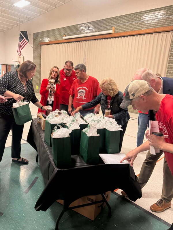 staff members handing out gifts in gift bags