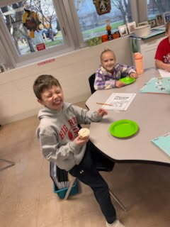 two students enjoying a cupcake