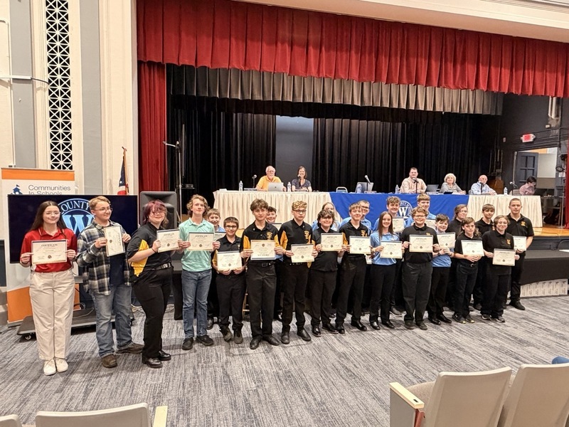 Group of students receiving awards and holding their certificates