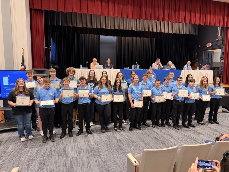 Group of students receiving awards and holding their certificates