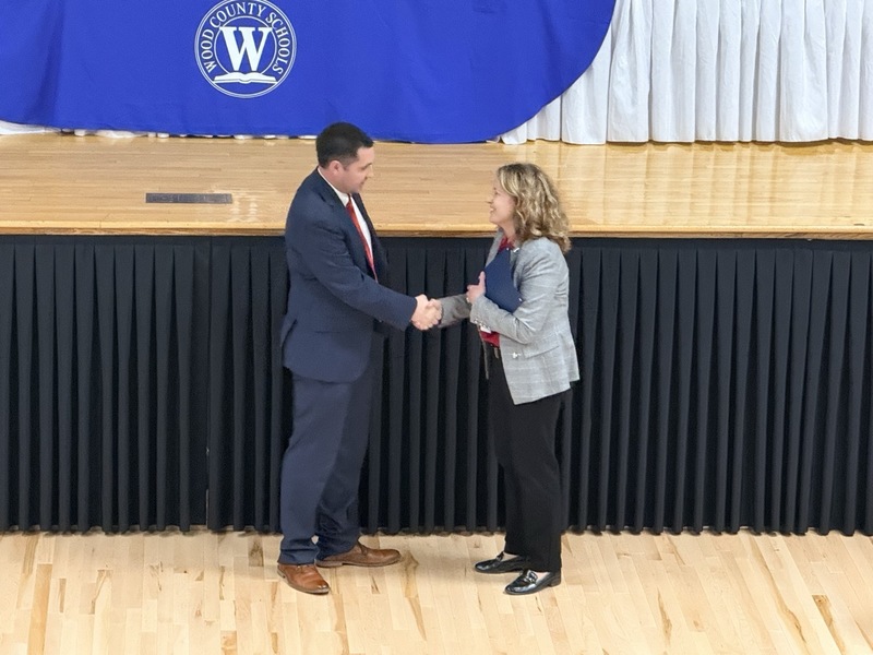 teacher of the year winner, Sam Vincent, appears with superintendent Christie Willis in Parkersburg High School Auditorium