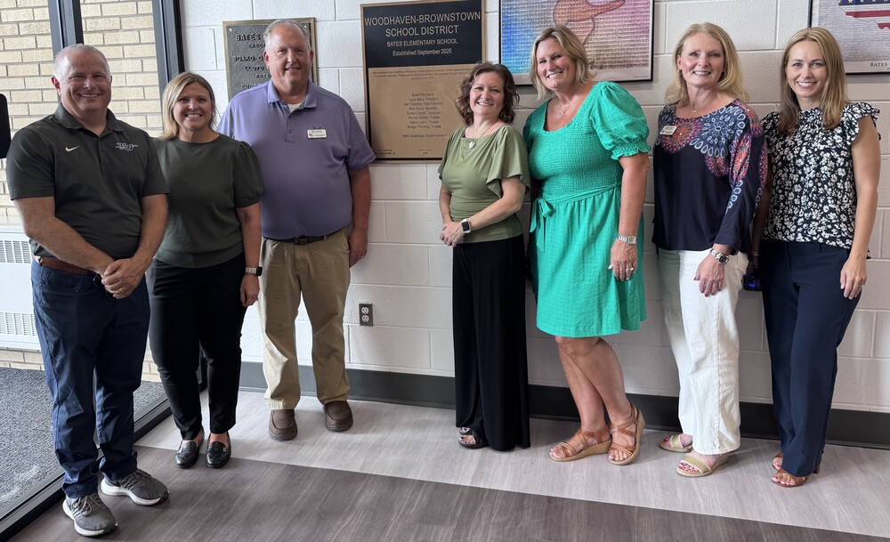 board of education with plaque at bates
