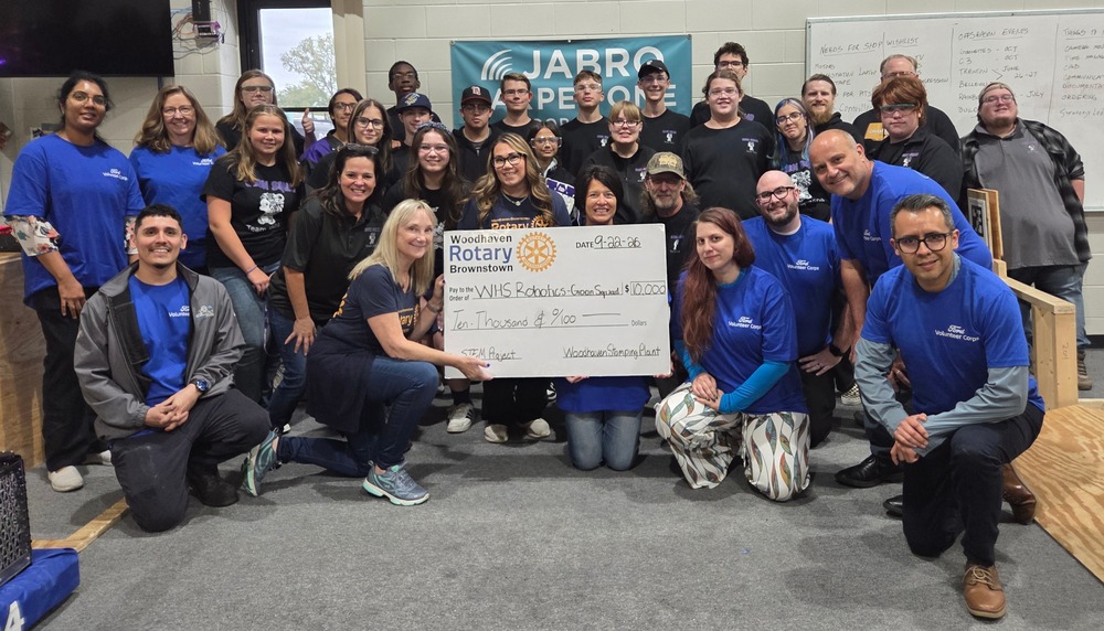 rotary and ford stamping donation to robotics people with a large check