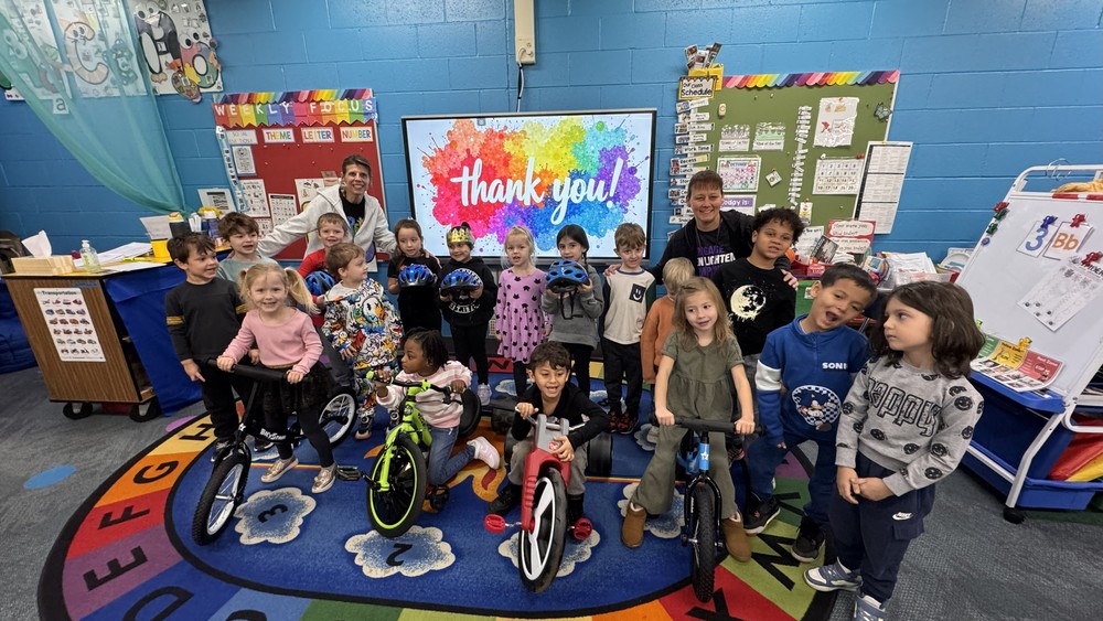 students with balance bikes
