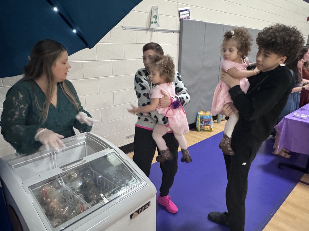 tote teacher giving ice cream to families