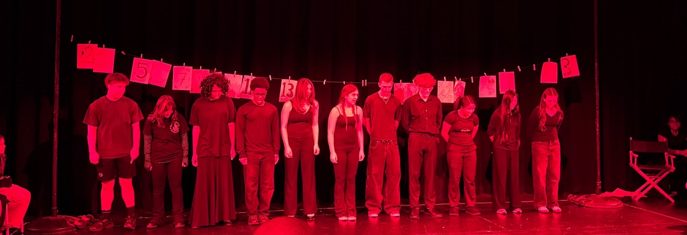 students in play on stage