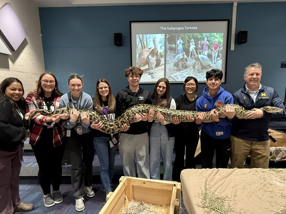 teachers holding a snake