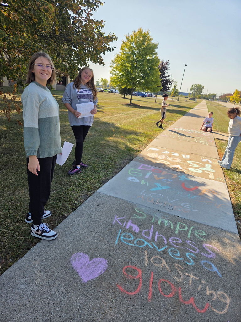 students drawing with sidewalk chalk