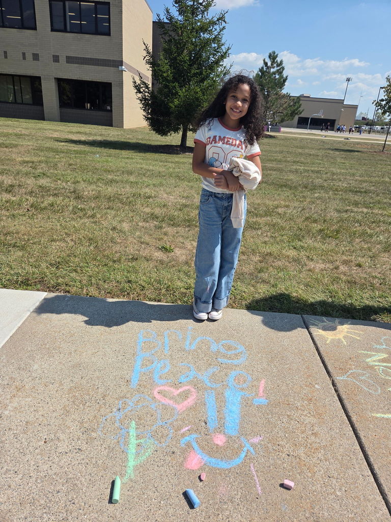 students drawing with sidewalk chalk