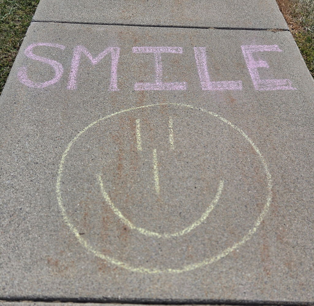 students drawing with sidewalk chalk
