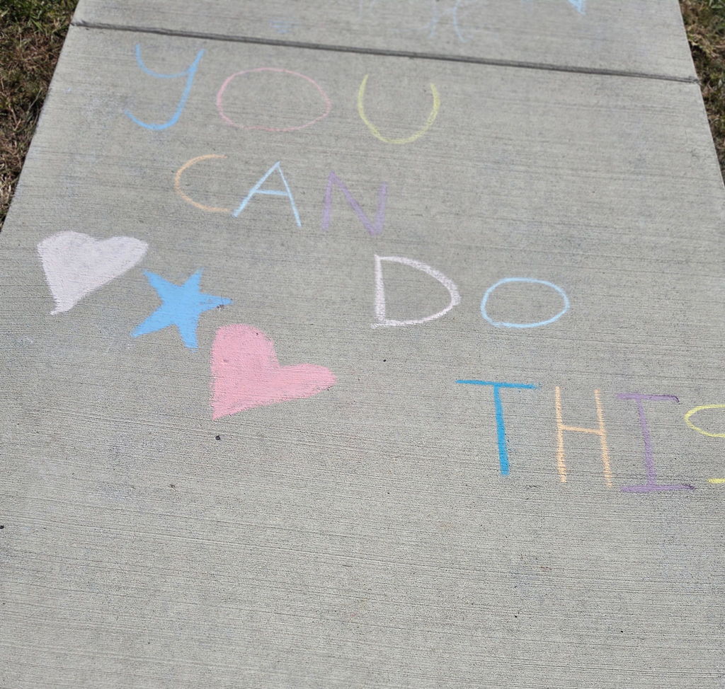 students drawing with sidewalk chalk
