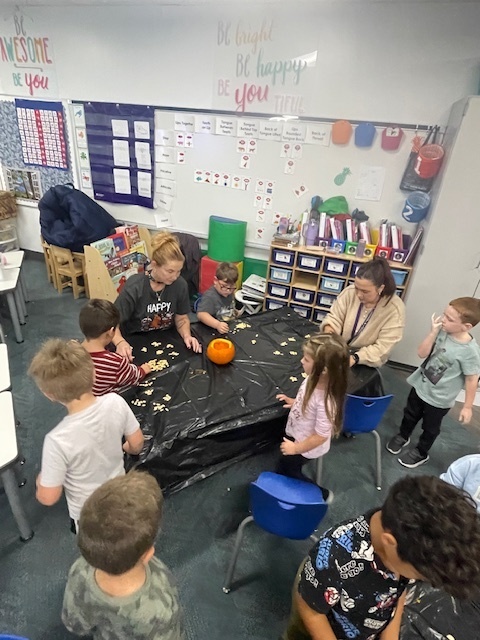 students carving pumpkins