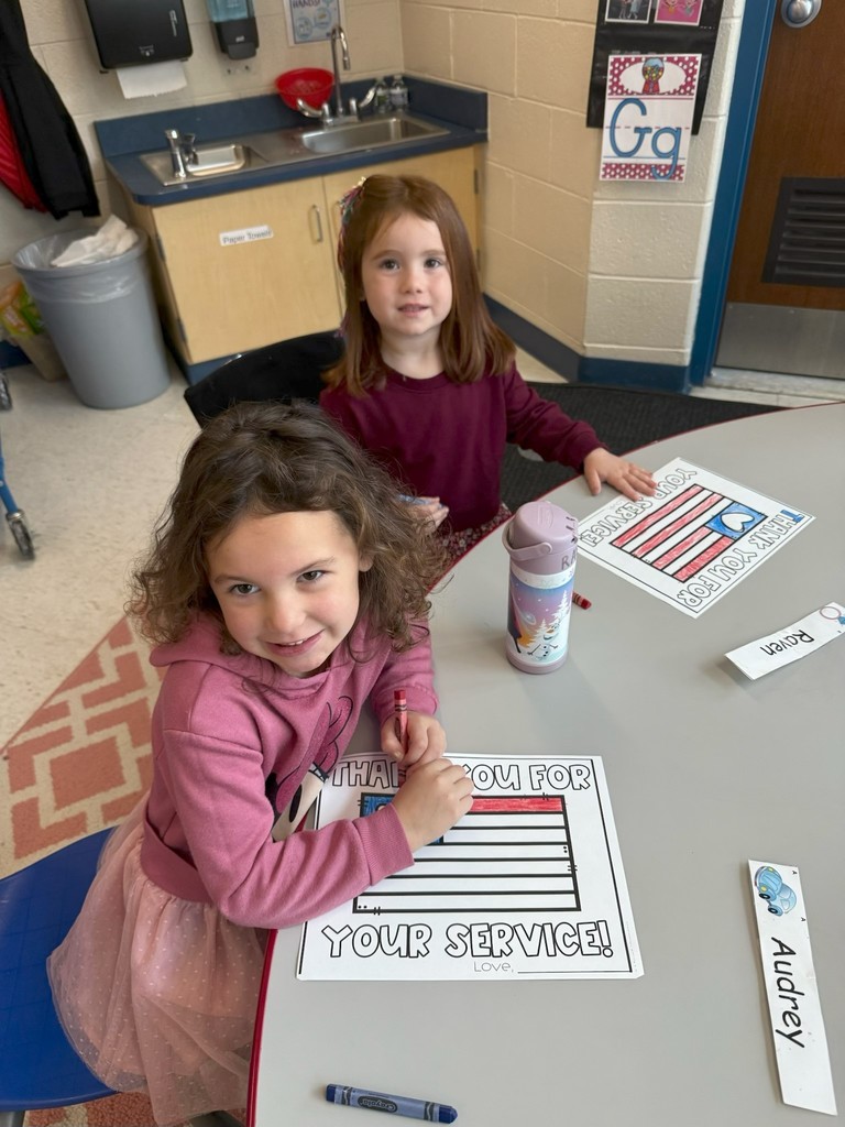 student with veterans day sign