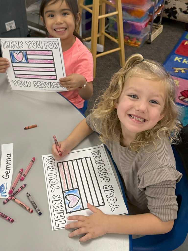 student with veterans day sign