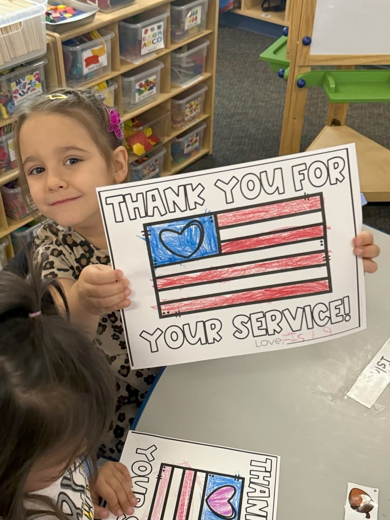 student with veterans day sign