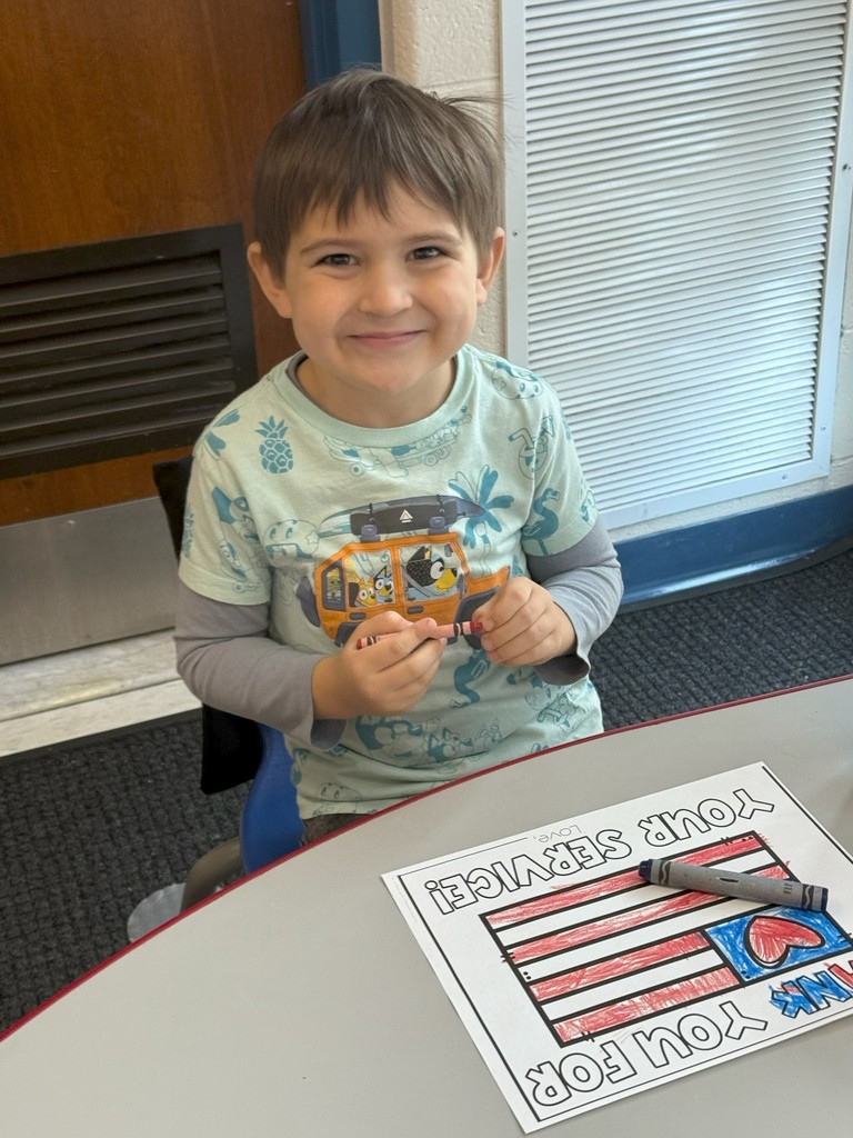 student with veterans day sign