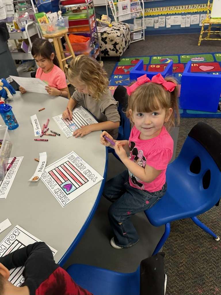 student with veterans day sign