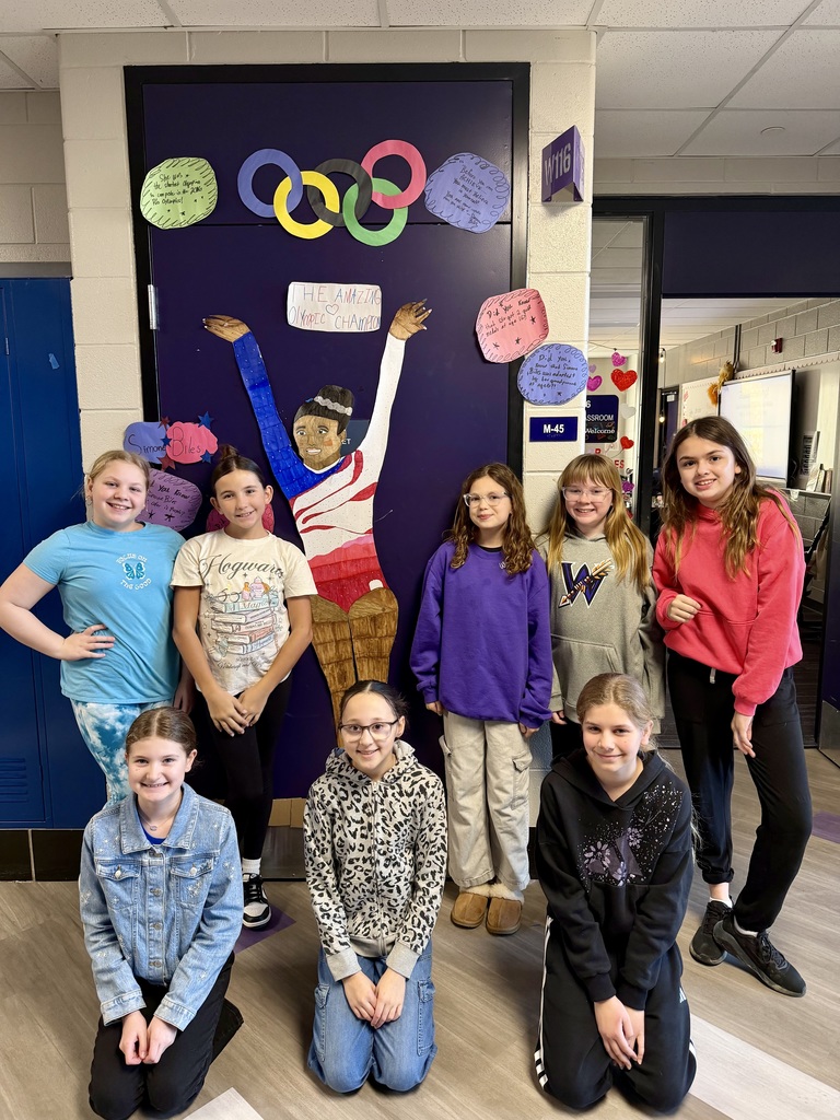 students with a lifesize Simone Biles poster