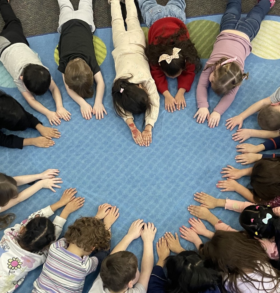 students in a heart shape with their hands