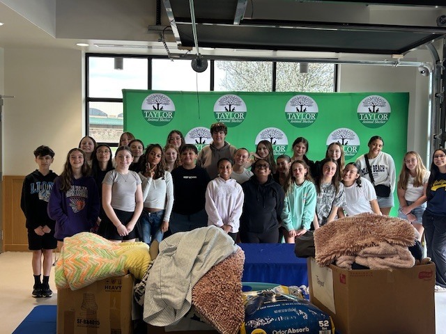students at taylor animal shelter with donations