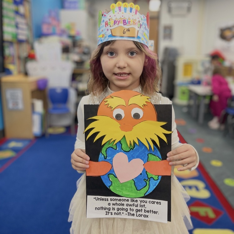student holding lorax