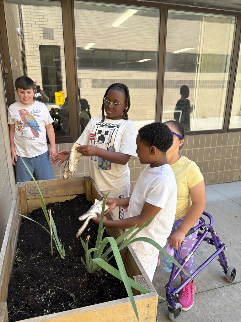 students weed and plant flowers at wue