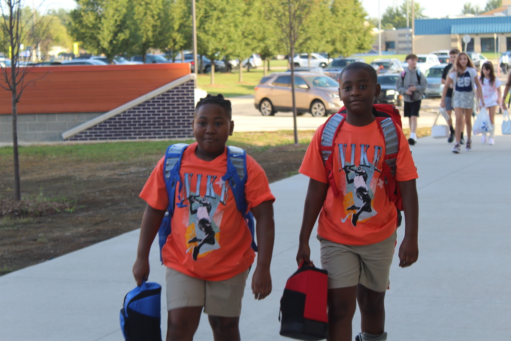 first day of school two boys in orange shirts