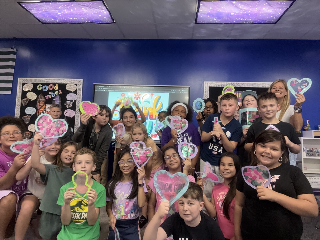 class holding suncatchers they made