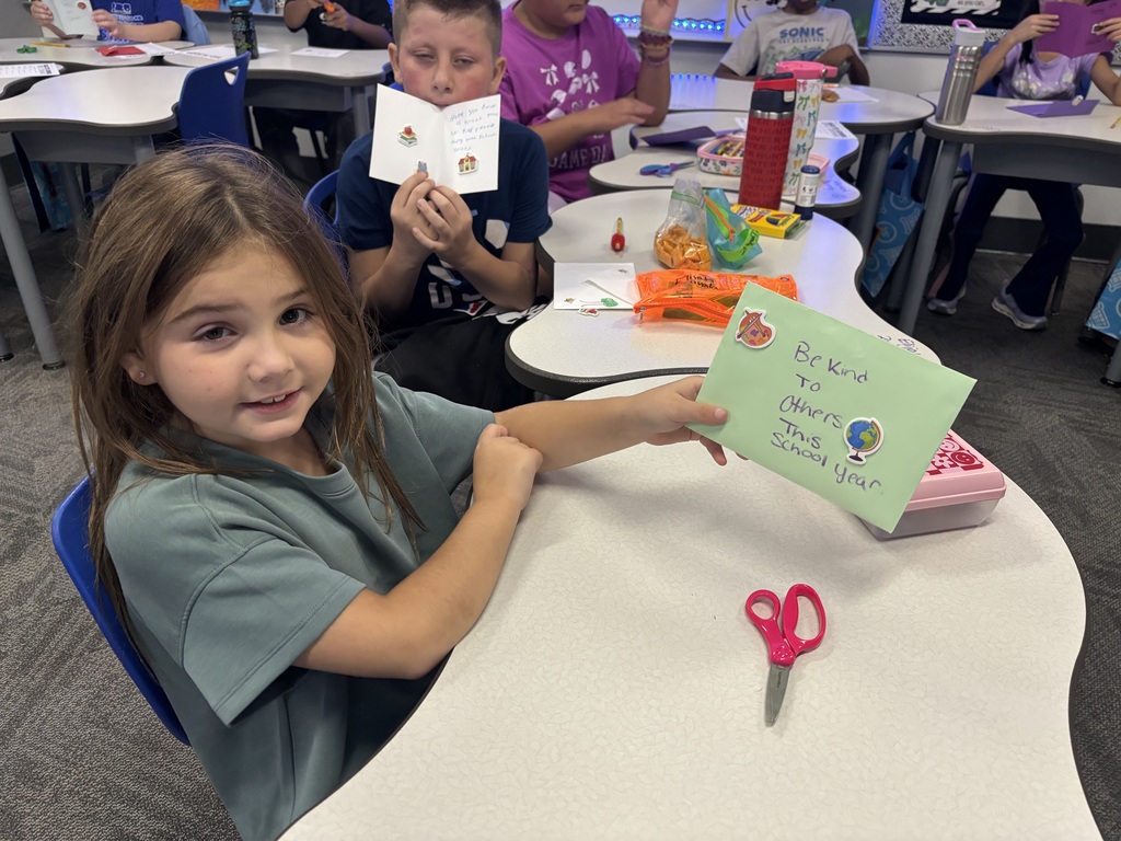 students holding cards