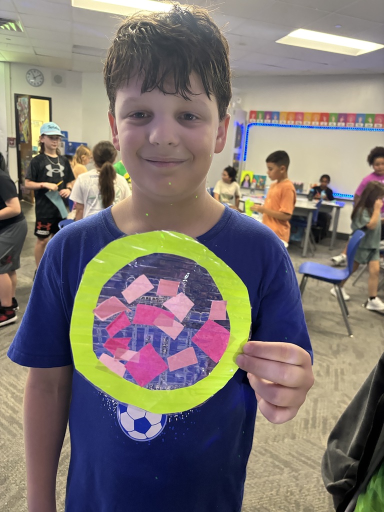 student holding suncatcher