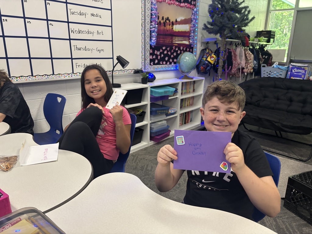 students holding cards