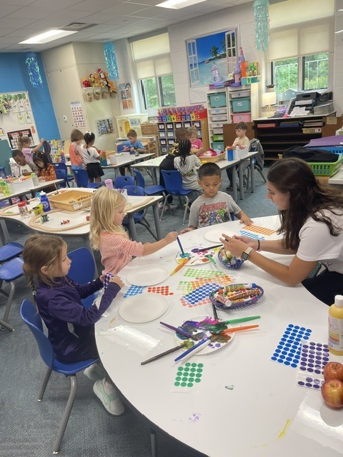 students putting dots on plates