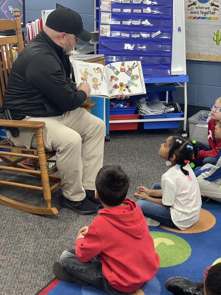 Bob McNamara reading a book to the kids