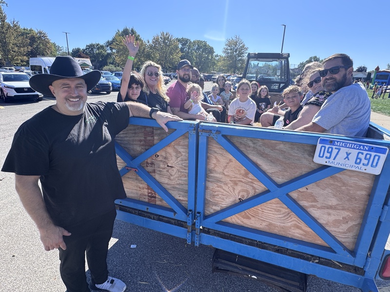 principal podlewski with a tractor full of parents and students