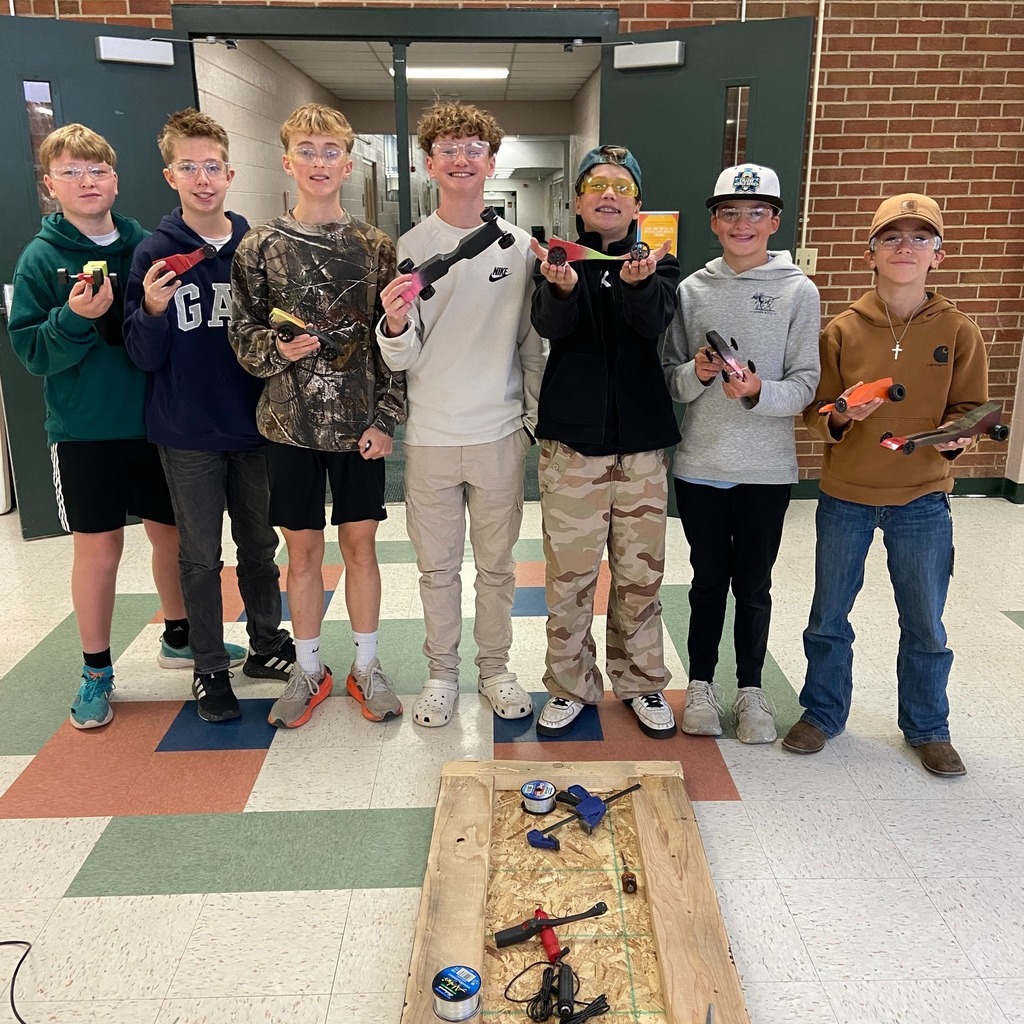 Woodshop students showing off their CO2 powered cars