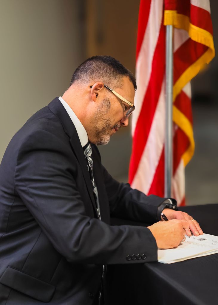 Mr. Robb Davidson signing his oath