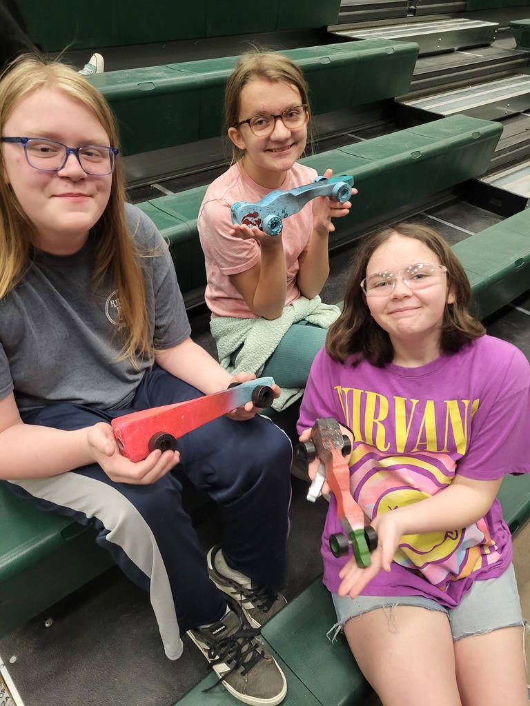 Three students posing with their CO2 cars