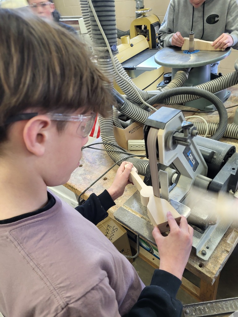 Student using Woodshop tools to build his CO2 car