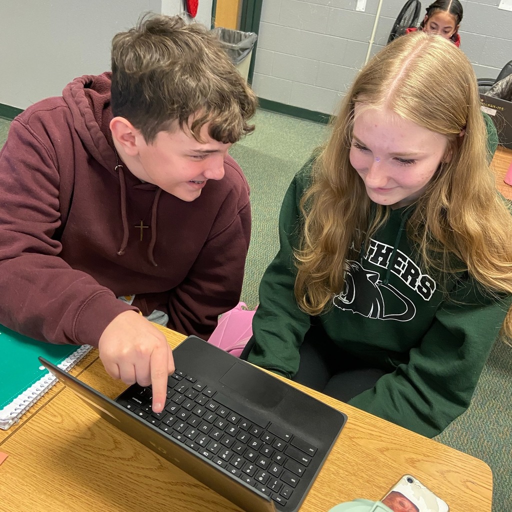 Two students peer editing during English class