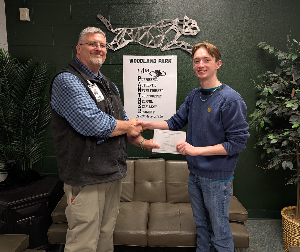 Mark Messner receiving his National Merit Scholarship certificate