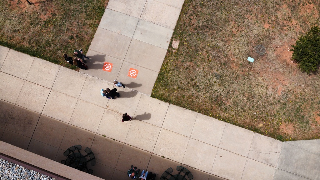 Aerial photo from a drone of students learning how to fly drones